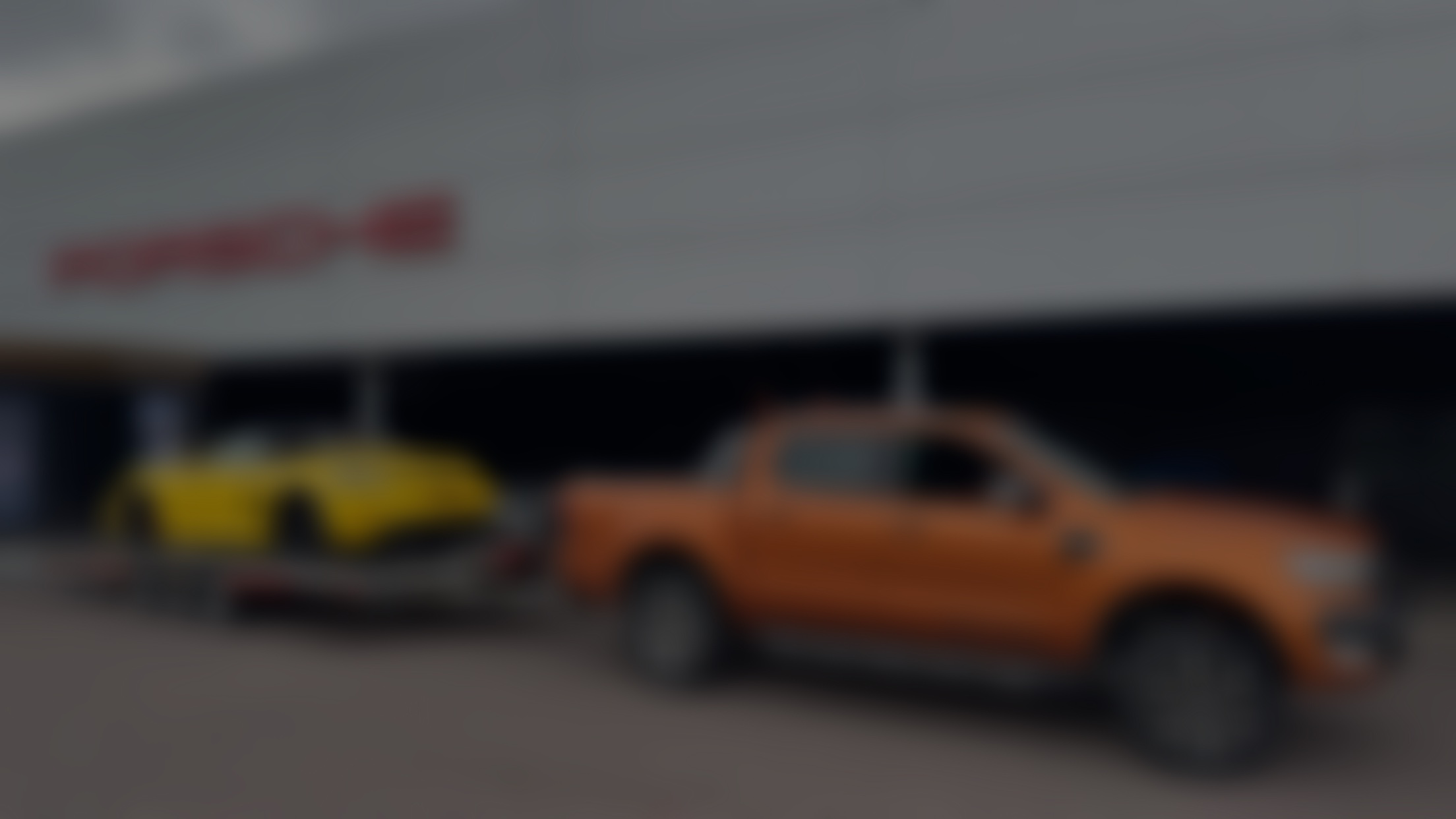 DSBM recovery truck towing a Porsche outside dealership