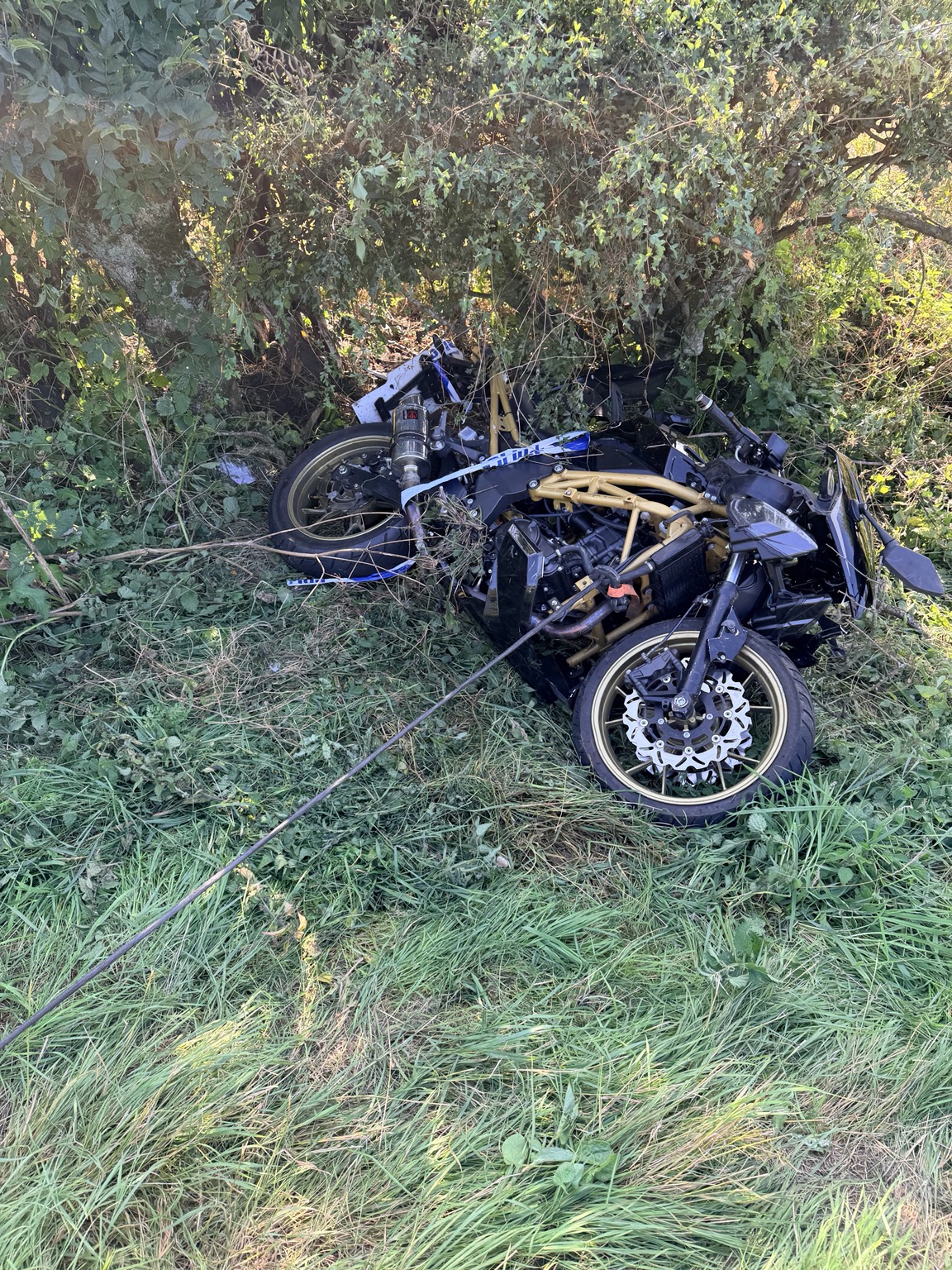 Damaged motorcycle at a rural recovery scene