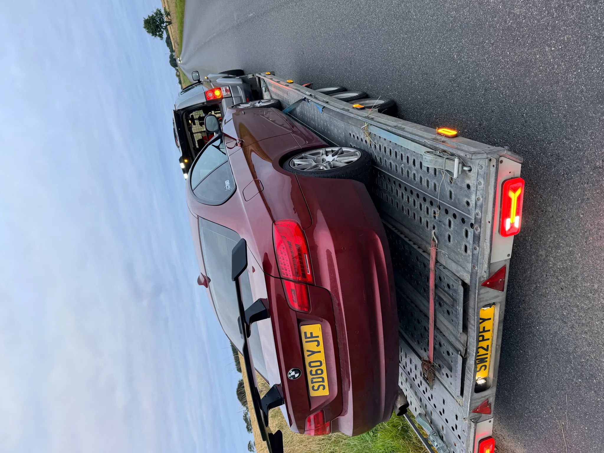 Maroon BMW coupe on the DSBM trailer, rural road